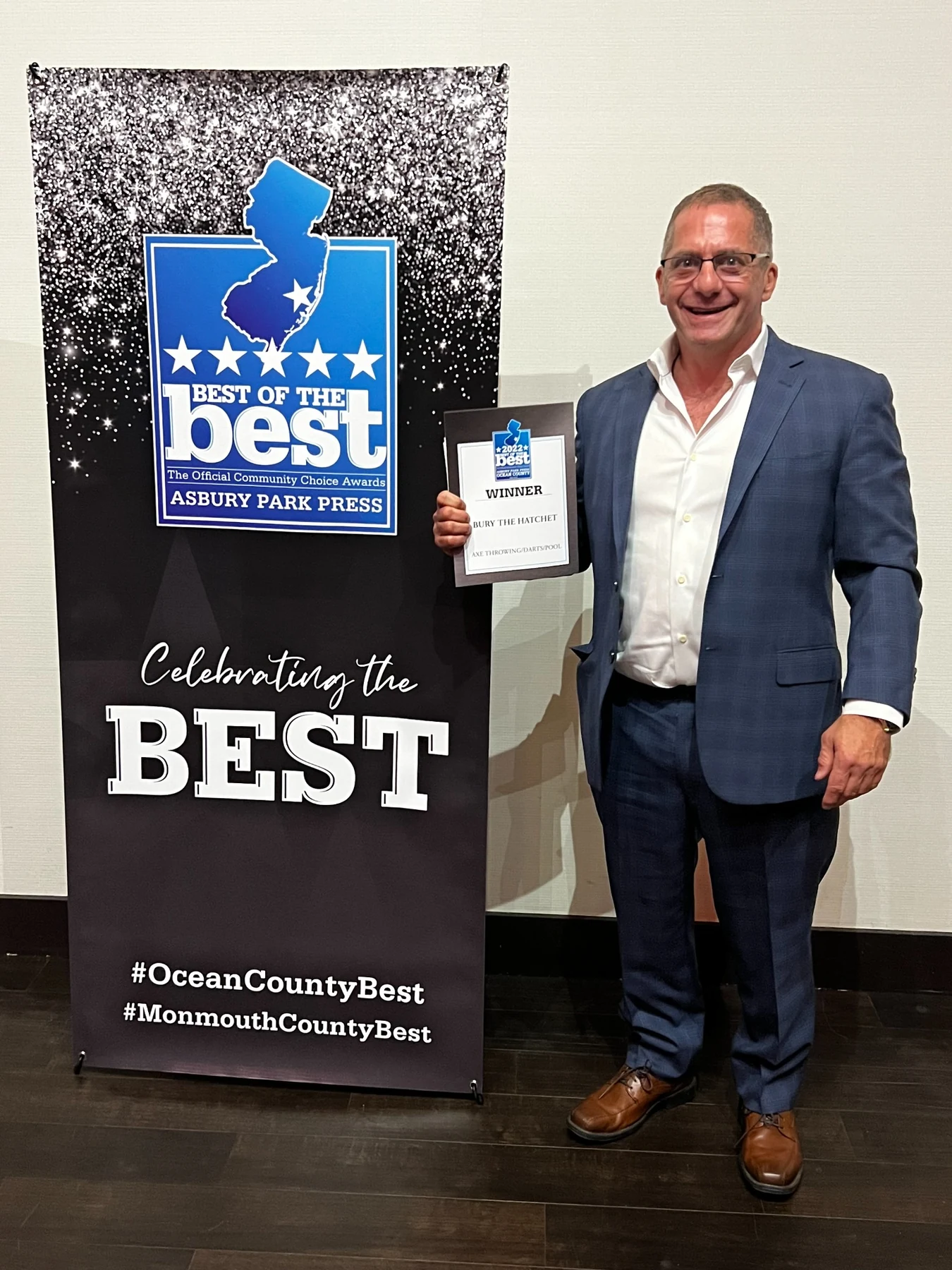Howard Klotzkin holding a Bury the Hatchet Best of the Best Community Choice Awards winner plaque