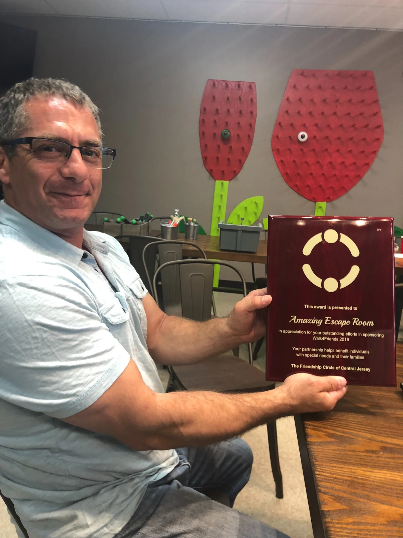 Howard Klotzkin with an Amazing Escape Room Walk4Friends 2018 sponsorship recognition plaque
